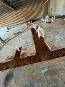 Slab trenching for plumbing pipes in Houston commercial building